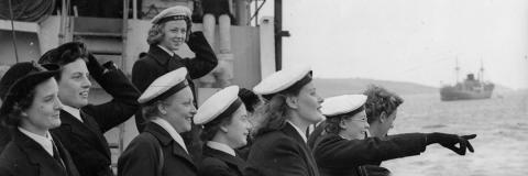 A black and white image of female sailors on board a ship at sea