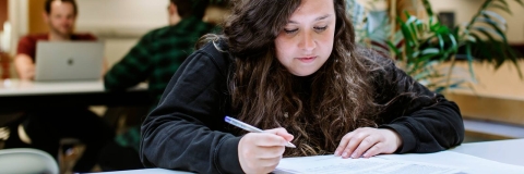 Female student with notebook and pen