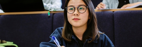 Female student taking notes in lecture