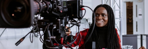 Student operating a camera