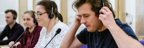 Male translator in speaking into microphone