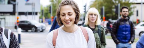 Master's scholarship student smiling on an International orientation walking tour