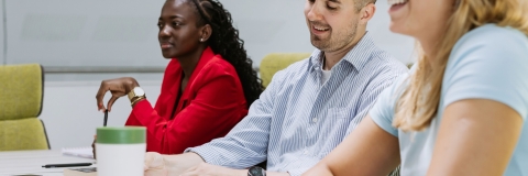 Colleagues discussing ideas in a meeting room