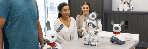 Students with humanoid and animalistic robots.