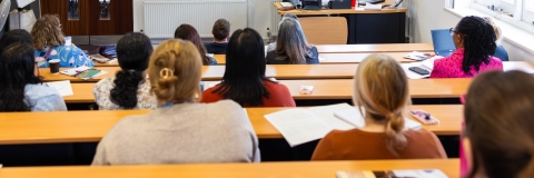University lecturer presenting to students in lecture theatre