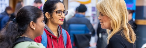 Two students and an adviser at a careers fair