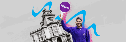 Male Student Ambassador with a tour paddle in front of Park Building