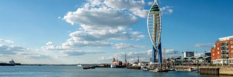Wide view of the sea and Spinnaker Tower on a sunny day.
