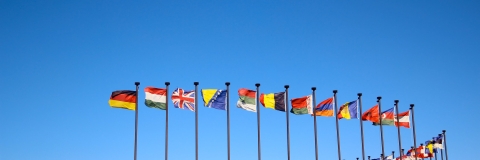 Flags of the world against blue sky
