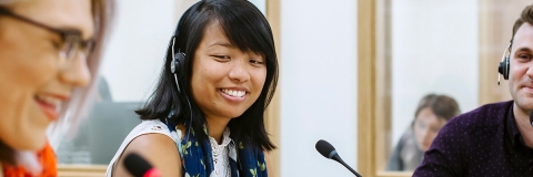 Women with headsets and microphones using University language labs
