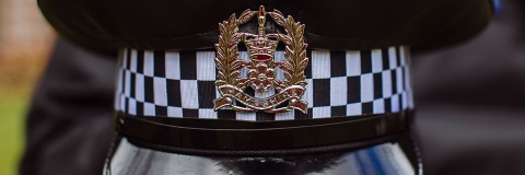 A close up of the police crest on a police hat