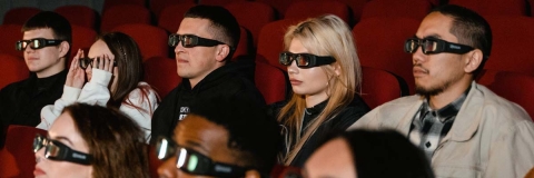 People watching a film in a cinema all wearing 3D glasses