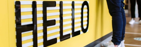 A yellow wall with hello written on it