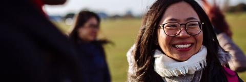 A female student from Hong Kong smiling on Southsea common