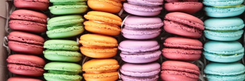 a stack of macarons in a variety of colours