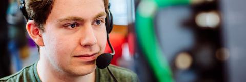 a male student from Latvia wearing a headset