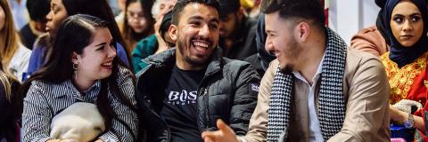 a male student from Libya laughing at a festival of cultures