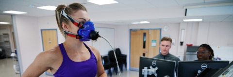 Student wearing a breathing monitoring mask