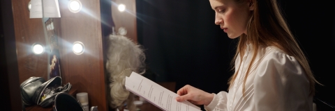 A theatre actor reading a script