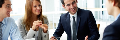 Colleagues discussing business challenges at a table