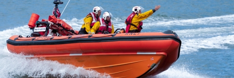 RNLI lifeboat crew in a boat on the water