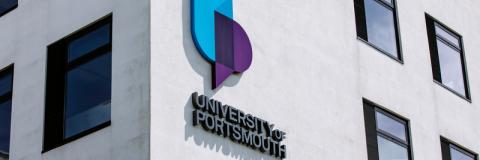 University of Portsmouth logo on white brick building