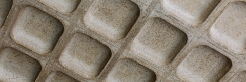  A grey textured surface with uniform rectangular indents.