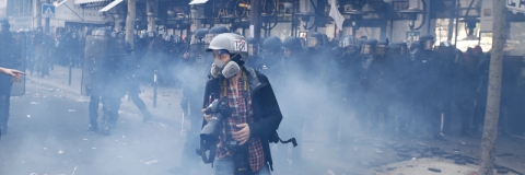 Photojournalist surrounded by riot police, Paris, France