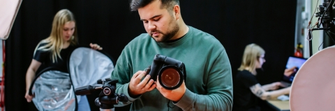 Male student working with photography equipment