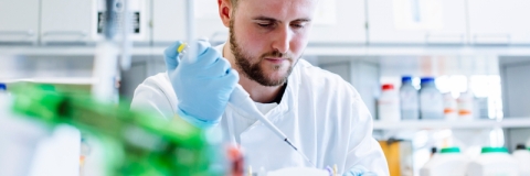 Male biology student working in the lab