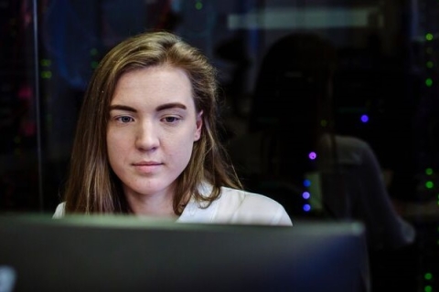 Female students sits in front of computer screen