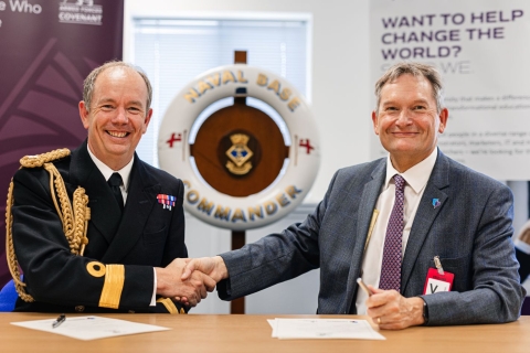 Naval Base Commander, Commodore John Voyce OBE ADC RN (left) signing the covenant with Professor Graham Galbraith, Vice-Chancellor of the University of Portsmouth