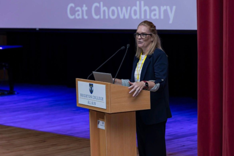 Cat presenting at a lectern