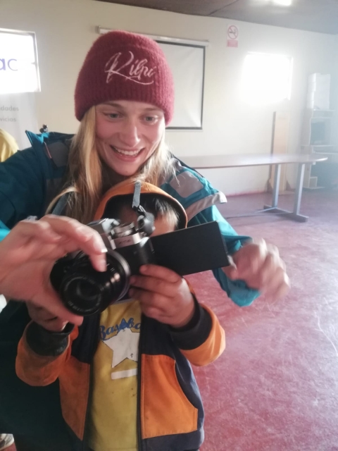 Eliska demonstrating how to use a camera