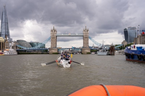 Ocean rowing boat heading towards Tower Bridge, London 