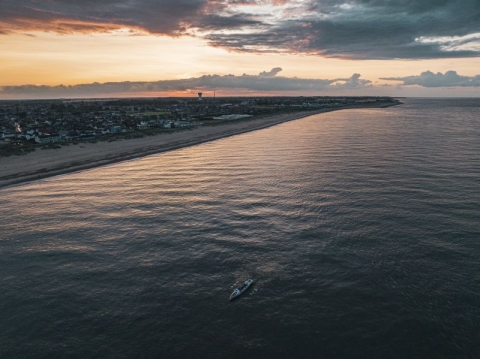 A rowing boat on the ocean taken from a drone