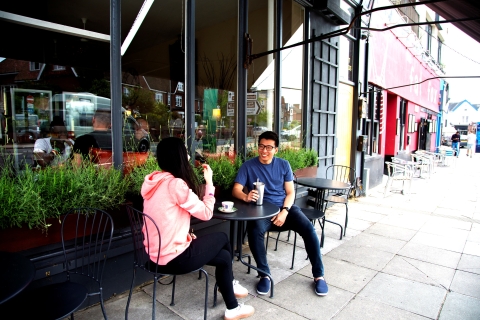 A man and woman sitting outside Garage Lounge enjoying their drinks