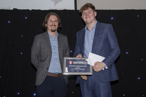 Denis Brzozowski at Hampshire FA presenting BA Journalism graduate Harry Ince his award in 2024