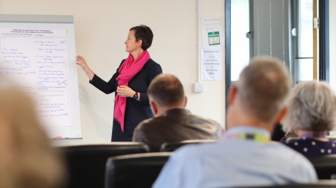 A member of staff describing what is written on a flip chart board