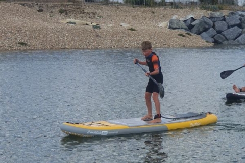 A young paddleboarder at Pagham beach