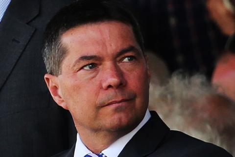 Mark Catlin looking to the side wearing suit in a photograph