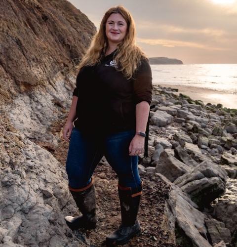 PhD student Megan Jacobs stood on a beach