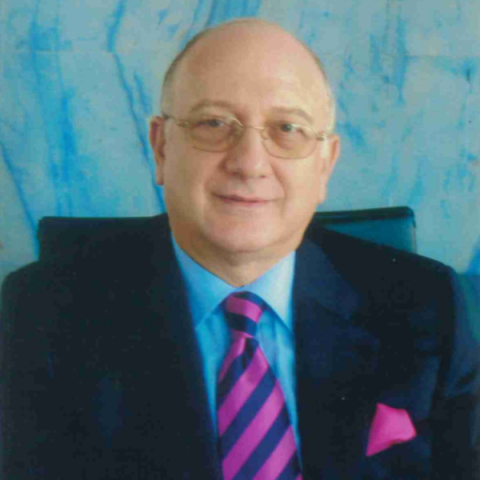 Headshot of Michael Erotokritos wearing suit and tie