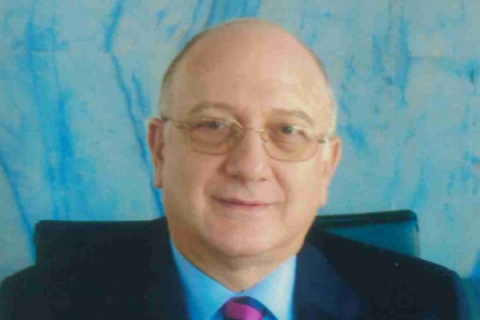 Headshot of Michael Erotokritos wearing suit and tie