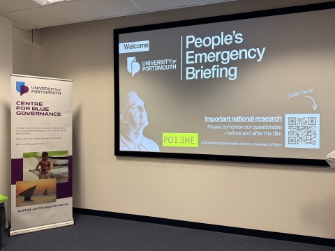 Lecture screen reading 'People's Emergency Briefing'