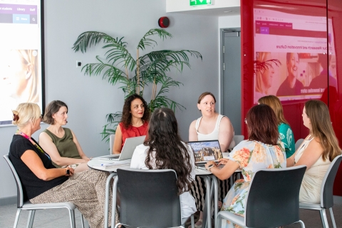 Women sitting at a table discussing business ideas