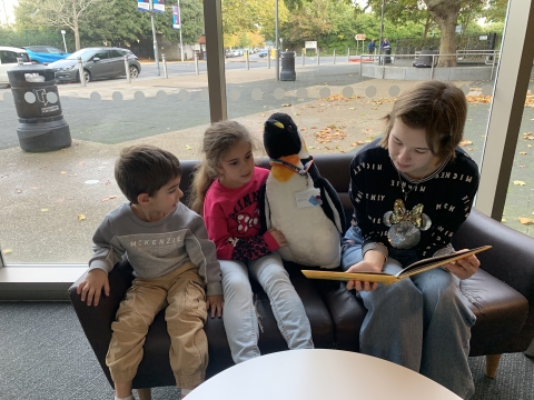 Poppy Ryder reading to children from the Portsmouth City of Sanctuary asylum seeker community.