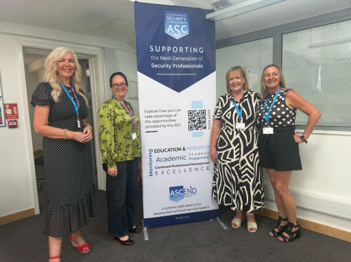 Kate Dawes, Dr Sophie Carr, Pam Whittemore, and Hayley Joseph in front of a ASC banner