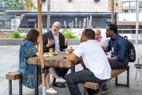 Five people sat around a table in discussion