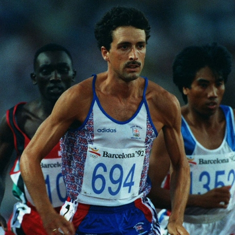 Graduate Tom Buckner during Olympics wearing branded vest top running
